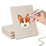 Hand punching one of the Unicorn and Frog mini canvases