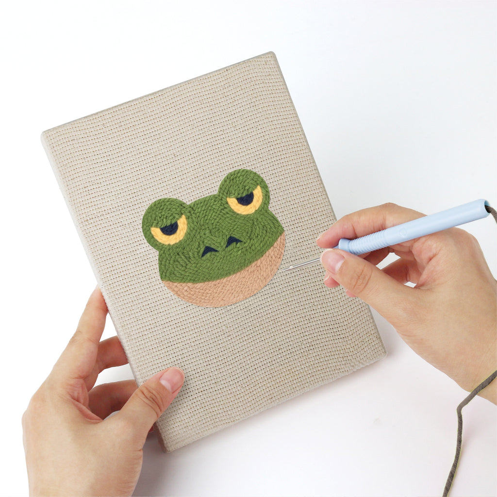 Punching a Unicorn and Frog mini canvas with the punch needle