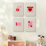 The four Valentine Notes mini canvases on a wall above a shelf