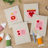 The four finished Valentine Notes mini canvases laid out on a table