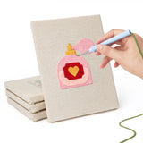 Hand punching one of the Valentine Notes mini canvases
