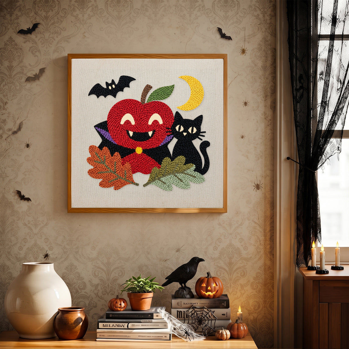 Finished Vampire Apple and Cat punch needle canvas on a wall