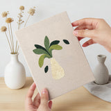 Hand holding a finished Vase Leaf Quartet mini canvas