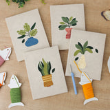 The four finished Vase Leaf Quartet mini canvases laid out on a table