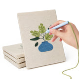 Hand punching one of the Vase Leaf Quartet mini canvases