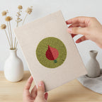 Hand holding a finished Veggie Circles mini canvas