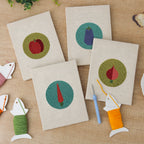 The four finished Veggie Circles mini canvases laid out on a table