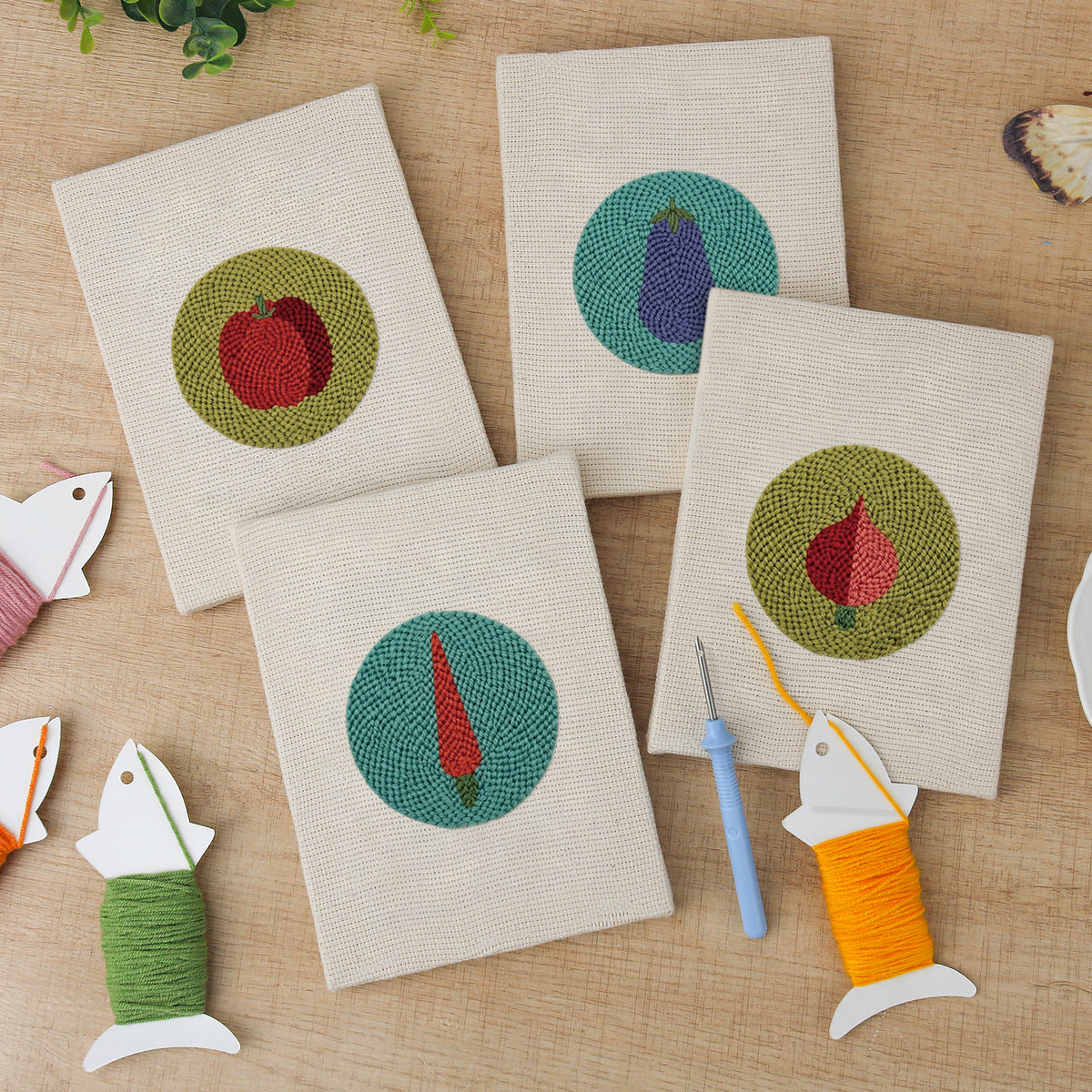 The four finished Veggie Circles mini canvases laid out on a table