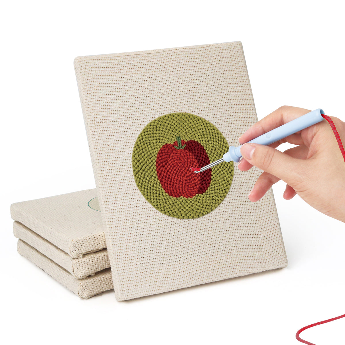 Hand punching one of the Veggie Circles mini canvases