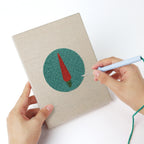 Punching a Veggie Circles mini canvas with the punch needle