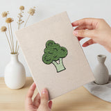 Hand holding a finished Veggie Patch mini canvas