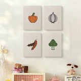 The four Veggie Patch mini canvases on a wall above a shelf