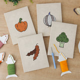 The four finished Veggie Patch mini canvases laid out on a table
