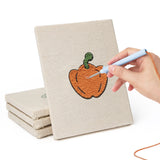 Hand punching one of the Veggie Patch mini canvases