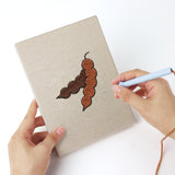 Punching a Veggie Patch mini canvas with the punch needle