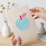 Hand holding a finished Watering Can Apples mini canvas