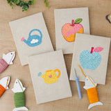 The four finished Watering Can Apples mini canvases laid out on a table