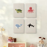 The four Whale and Orca mini canvases on a wall above a shelf