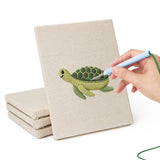 Hand punching one of the Whale and Orca mini canvases