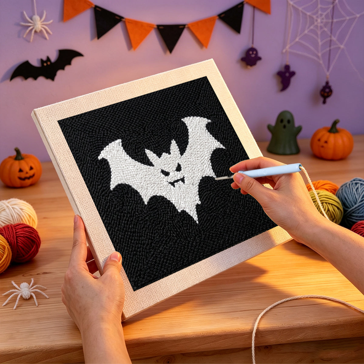 Punching the White Bat on Black design with the punch needle