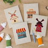 The four finished Windmill Village mini canvases laid out on a table