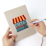 Punching a Windmill Village mini canvas with the punch needle