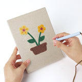 Punching a Windowsill Blooms mini canvas with the punch needle