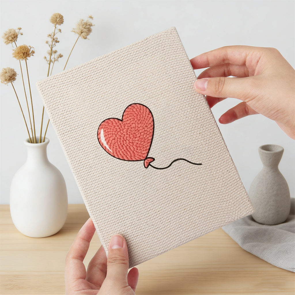 Hand holding a finished Winged Heart Mix mini canvas
