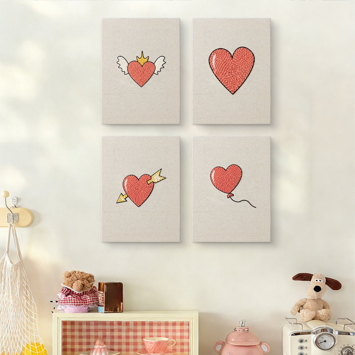 The four Winged Heart Mix mini canvases on a wall above a shelf