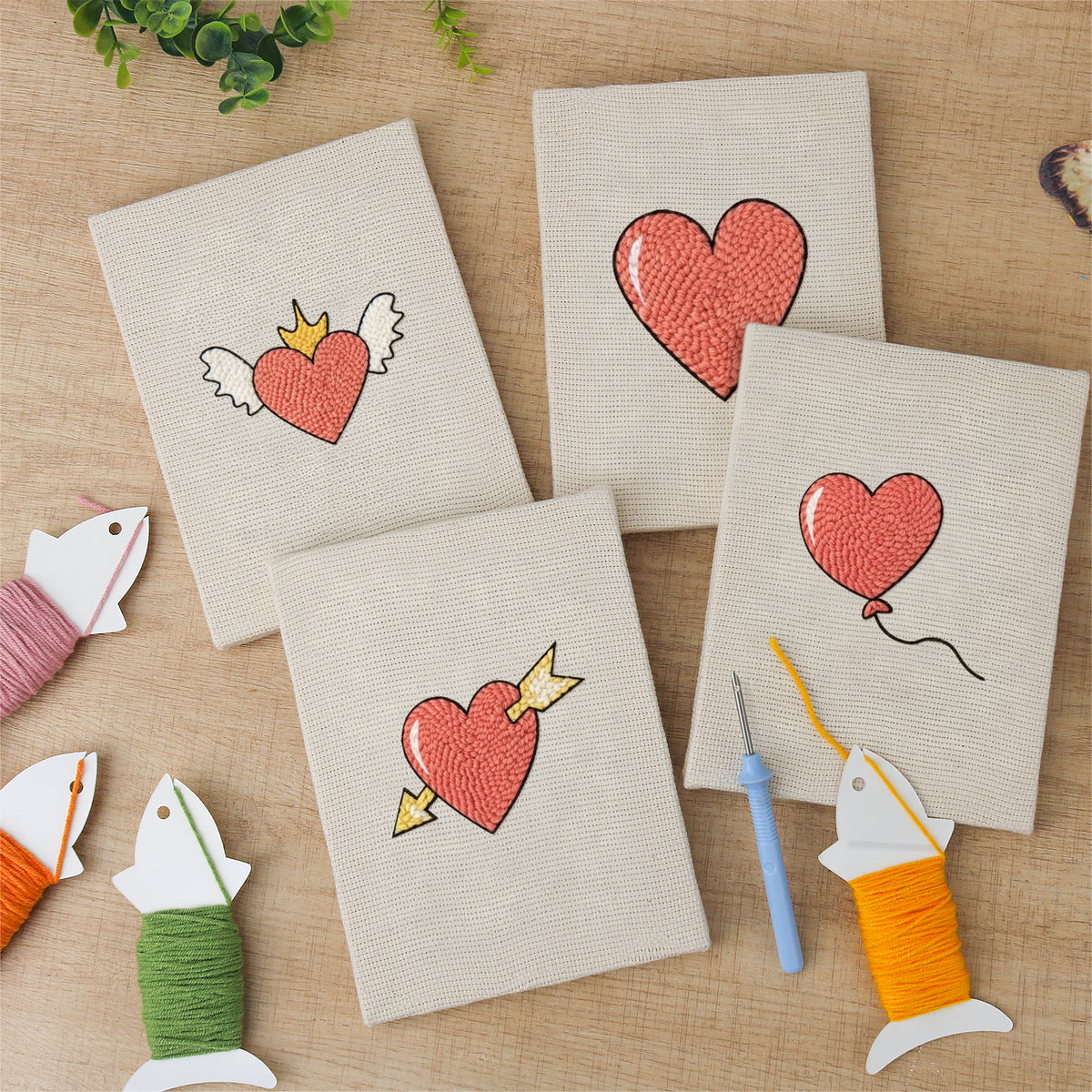 The four finished Winged Heart Mix mini canvases laid out on a table