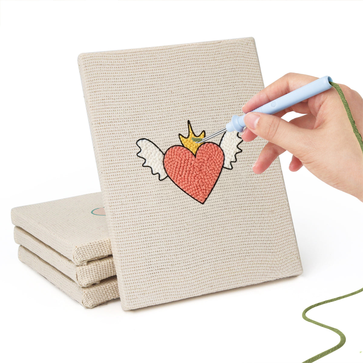 Hand punching one of the Winged Heart Mix mini canvases