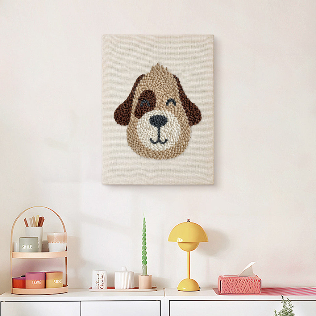 Finished Winking Puppy punch needle canvas on a wall