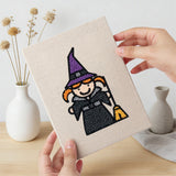 Hand holding a finished Witch and Bunting mini canvas