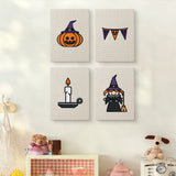 The four Witch and Bunting mini canvases on a wall above a shelf