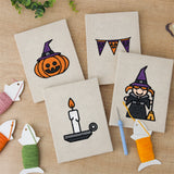 The four finished Witch and Bunting mini canvases laid out on a table