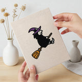 Hand holding a finished Witch and Cauldron mini canvas
