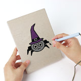 Punching a Witch and Cauldron mini canvas with the punch needle