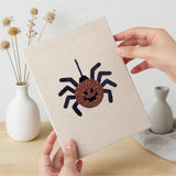 Hand holding a finished Witch and Spider mini canvas