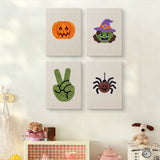 The four Witch and Spider mini canvases on a wall above a shelf