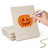 Hand punching one of the Witch and Spider mini canvases