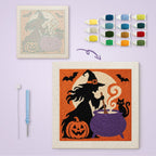 Witch at the Cauldron canvas before and after punching, with the threads and tools
