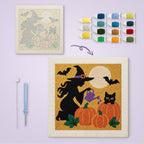 Witch Watering Pumpkins canvas before and after punching, with the threads and tools