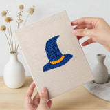 Hand holding a finished Wizard Hat Pumpkin mini canvas