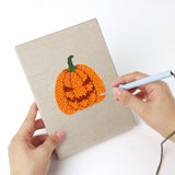 Punching a Wizard Hat Pumpkin mini canvas with the punch needle