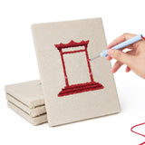 Hand punching one of the World Landmarks mini canvases