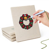 Hand punching one of the Wreath and Bell mini canvases