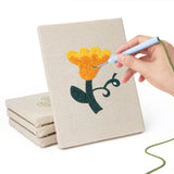 Hand punching one of the Yellow Folk Flowers mini canvases