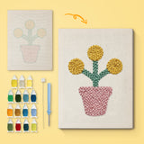 Yellow Pom Flowers canvas before and after punching, with the threads and tools