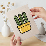 Hand holding a finished Yellow Pot Cacti mini canvas