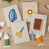 The four finished Yellow Scissors Desk mini canvases laid out on a table
